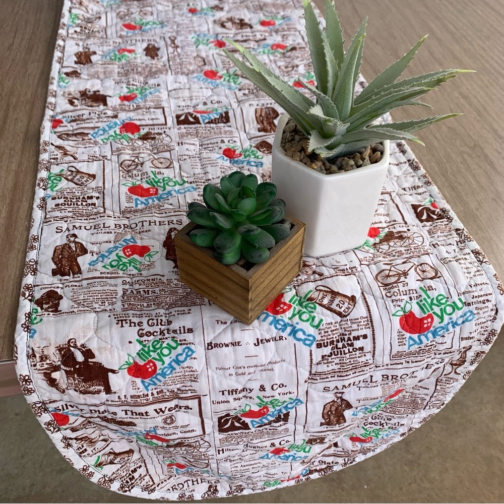 Vintage quilted table runner with a vintage newspaper print pattern. 13 X 38 MCM